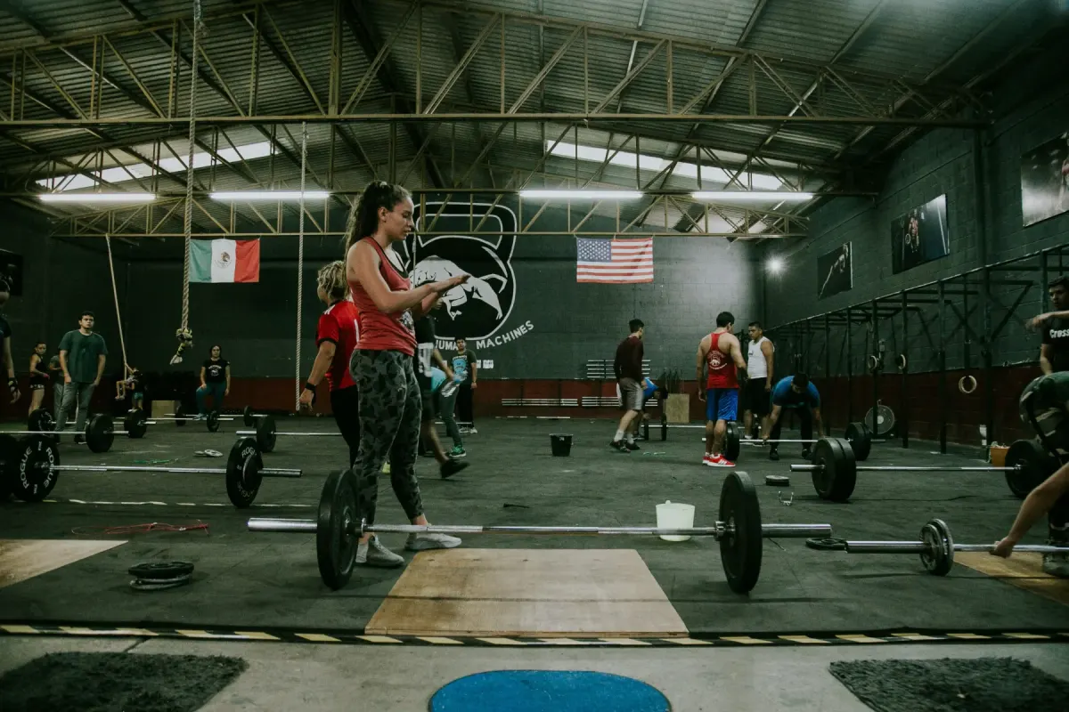 Coach leading athletes through a gym workout